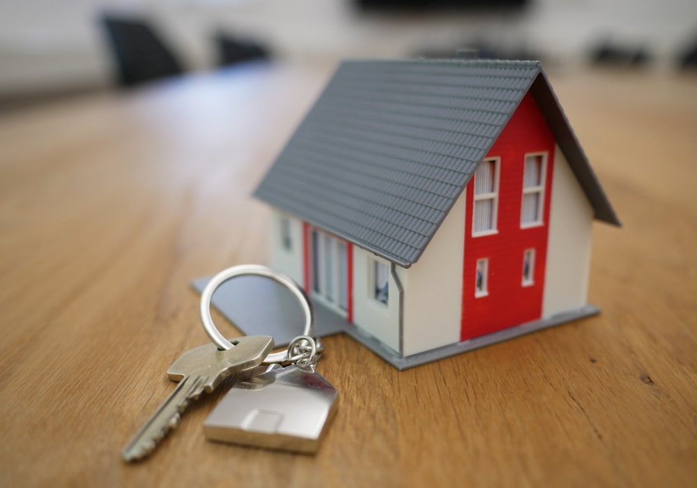 Model home and house keys representing insurance coverage