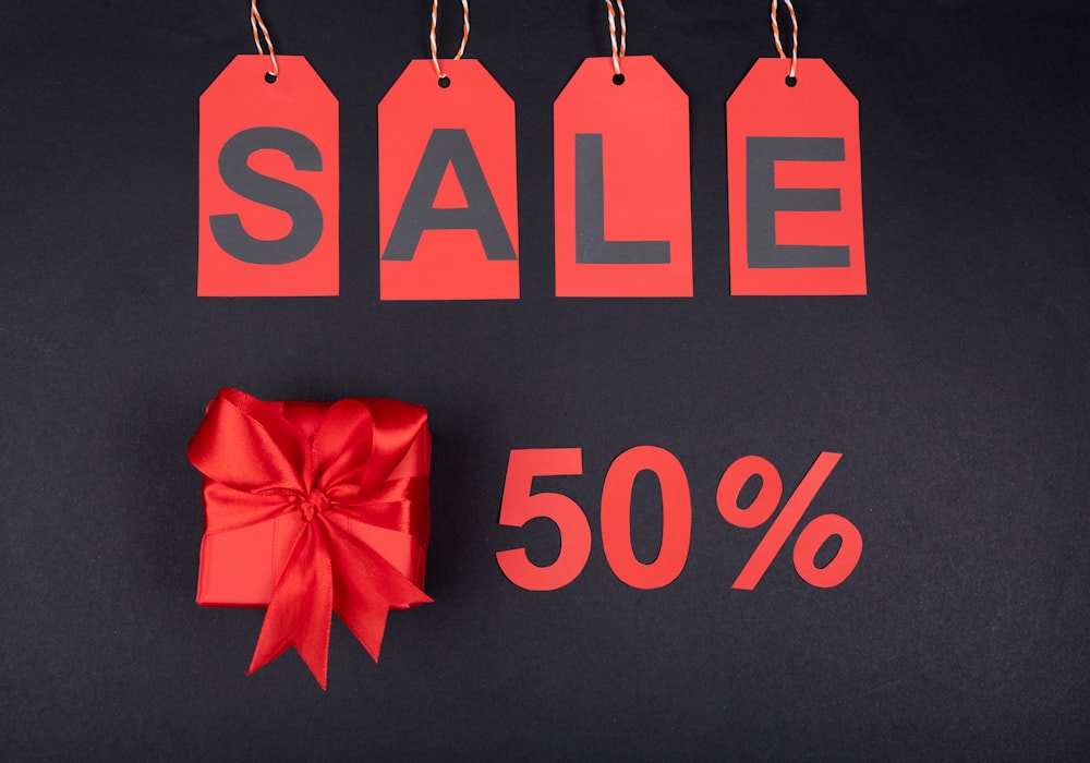 Retail sale tags and a wrapped gift on a dark background